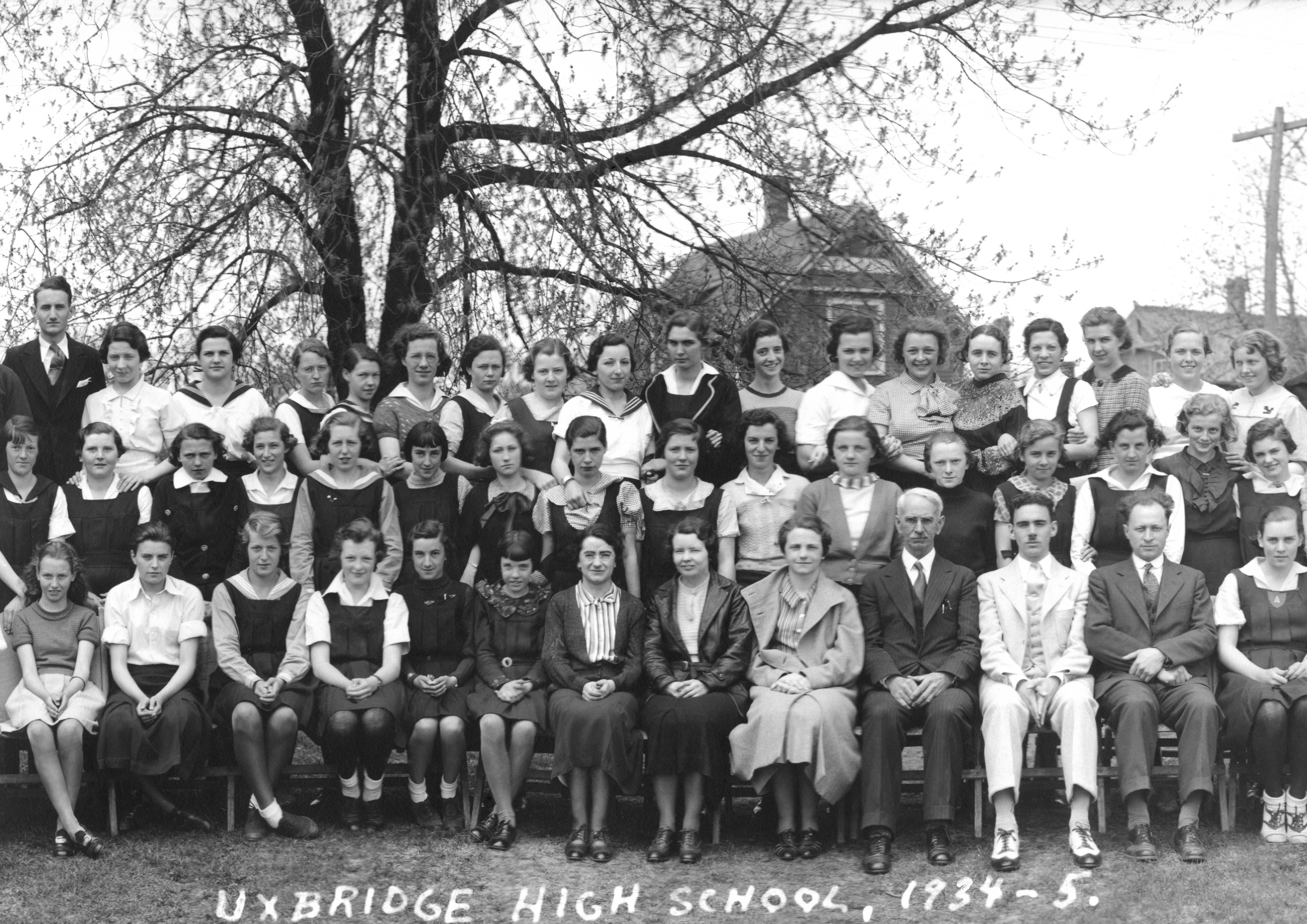 (Click to magnify (multiple levels of magnification)) ... warning very large file size  ... this photo was scanned at 2400 dpi and subsequently photoshopped to eliminate water damage and other visual artifacts). The principal, J.E. Burchell, is in the fro